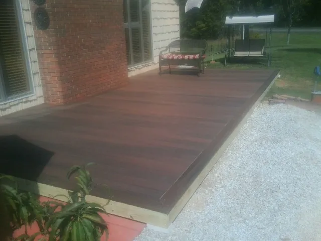 Freshly stained wood deck built against a brick home in North Miami Beach